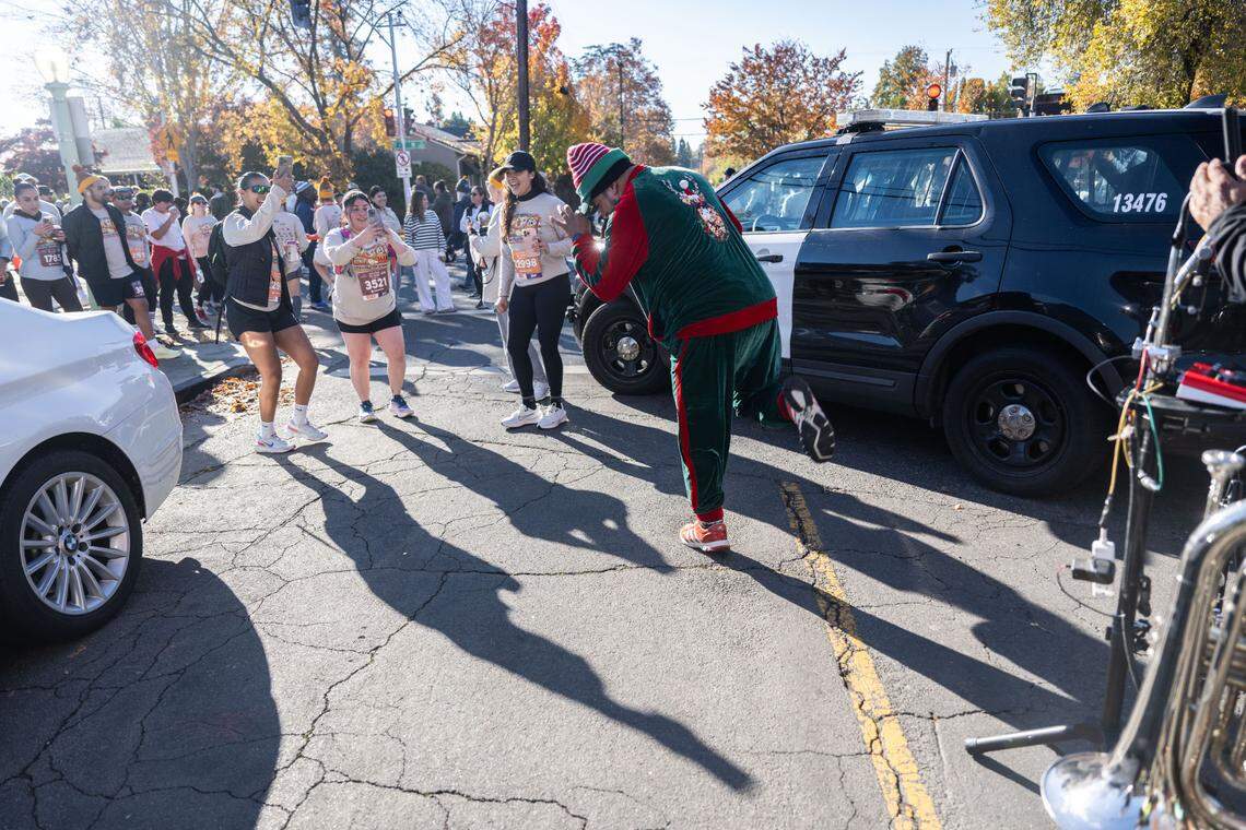 Paul Cobb dances as Los Juarez Mariachi plays during the Run to Feed the Hungry on Thursday near H Street in East Sacramento.