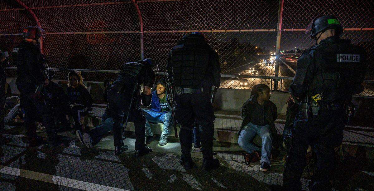 Protesters from a Stephon Clark march in East Sacramento are arrested by Sacramento police on a bridge over Highway 50 on Monday.