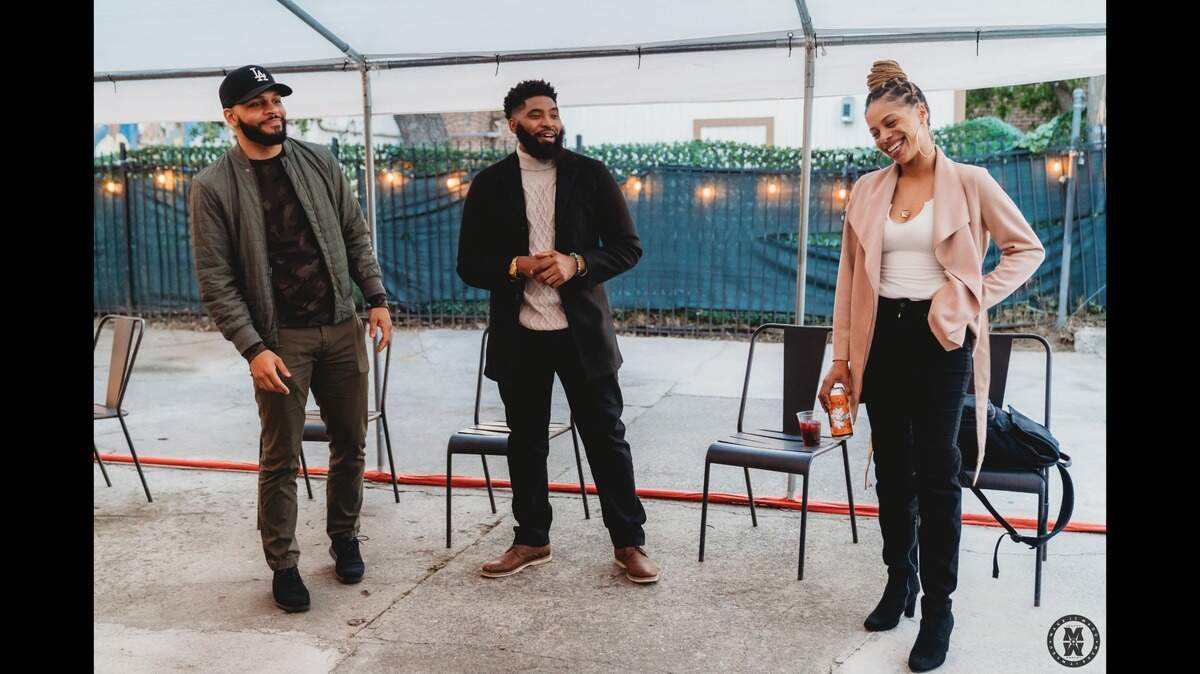 Cherokee Moore (left), Kelan Johnson (center), and Brittany Claypool (right) share a moment while speaking during mixer event.