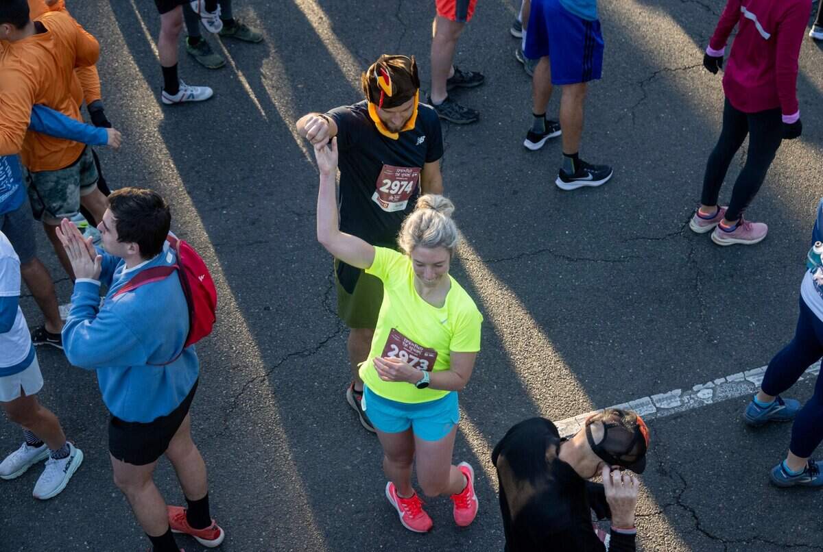 Bryan Lantz dances with Sarajo Sinnoff before the start of the Run to Feed the Hungry in Sacramento on Thursday.