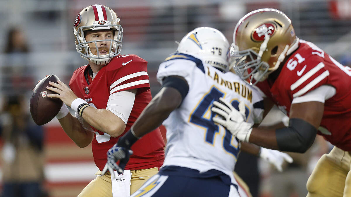 San Francisco 49ers quarterback C.J. Beathard, left, passes against the Los Angeles Chargers during the first half of an NFL preseason football game in Santa Clara, Calif., Thursday, Aug. 30, 2018.