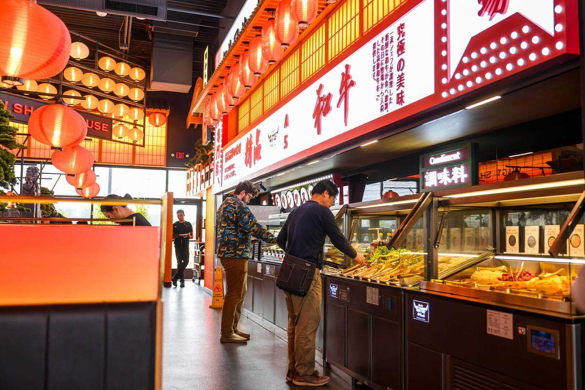 Diners select vegetables and sauces at Chubby Cattle, a wagyu beef hot pot restaurant in the Sakura Novi development in Novi, Mich., on Feb. 28. The fast-growing chain, founded in 2015, is preparing to open a Roseville restaurant as part of its broader U.S. expansion.