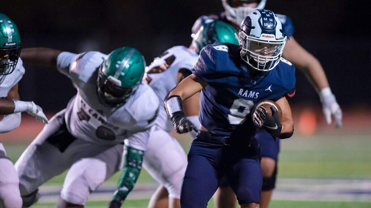 Casa Roble Rams running back Josh Taylor (8) rushes for a first down past El Camino Eagles defense during the first quarter in a Division V Sac-Joaquin Section Section first round football playoff game at Casa Roble High School in Orangevale on Friday, Nov. 5, 2021. Taylor had five touchdowns and rushed for 267 yards. The Rams won 51-34.