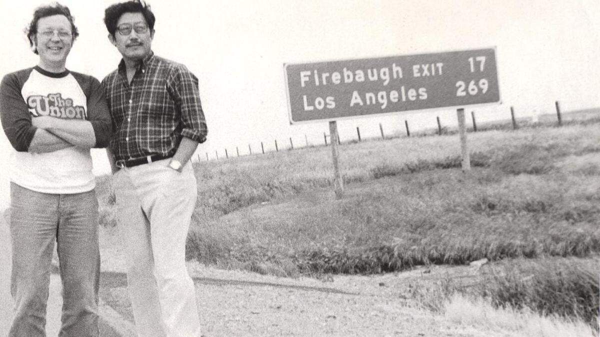Steve Chanecka, left, and K.W. Lee, right, pose on I-5.
