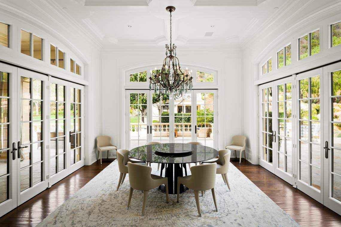 The prestigious gated European-style compound spans nearly 30,000 square feet with 12 bedrooms and 20 bathrooms.