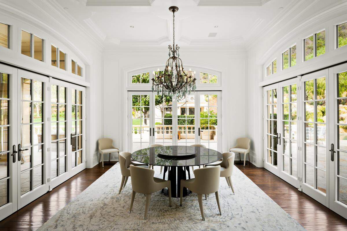 The prestigious gated European-style compound spans nearly 30,000 square feet with 12 bedrooms and 20 bathrooms.