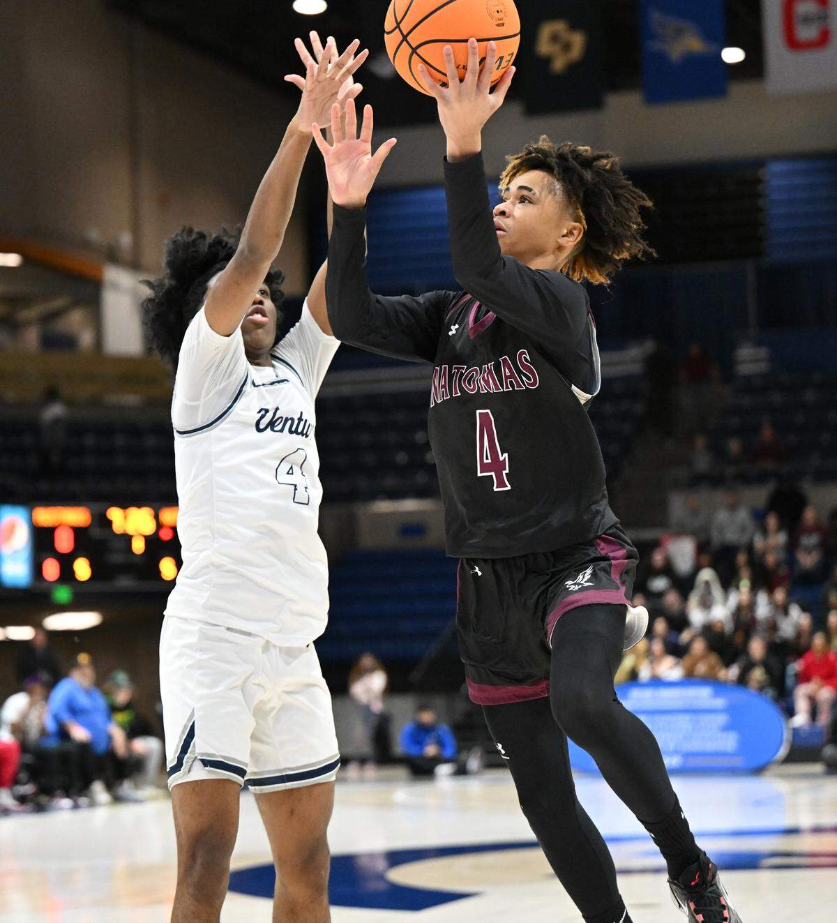 Natomas’ Manno Jenkins scores on a layup as Venture Academy DaeLeon Neal defends during the 2024 Sac-Joaquin Section Division IV championship game at UC Davis.