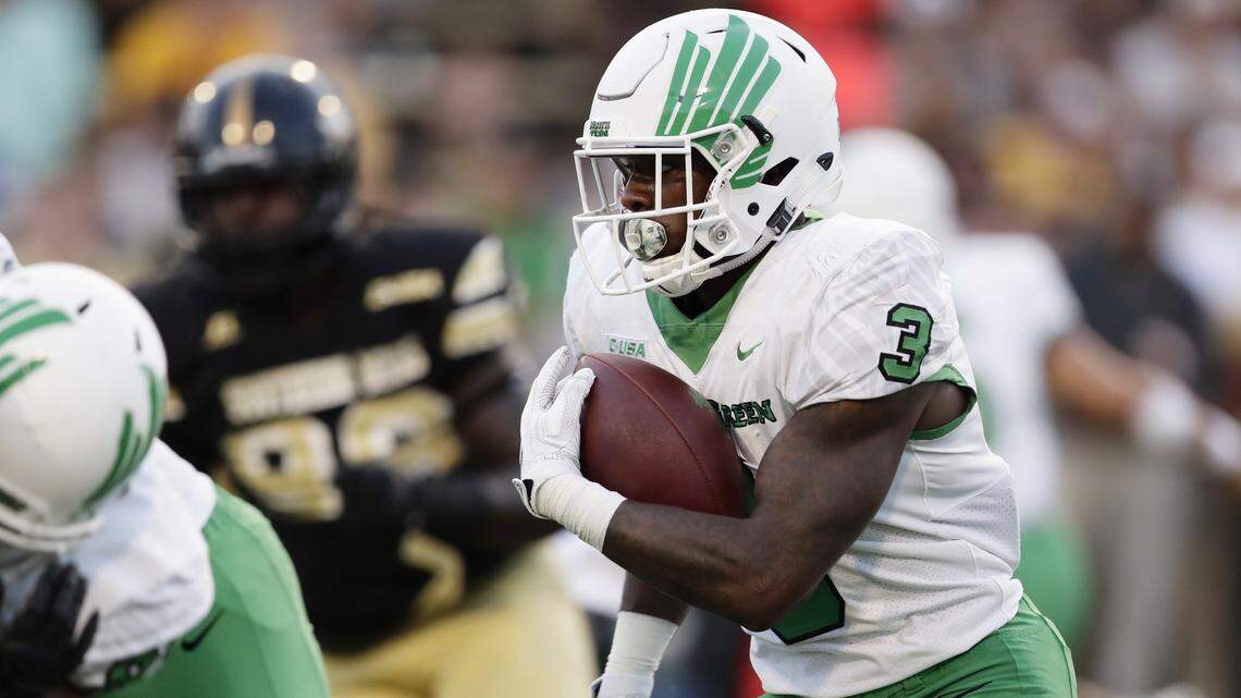 North Texas running back Jeffery Wilson (3) evades Southern Mississippi defenders for a long run during the first half of their NCAA college football game in Hattiesburg, Miss., Saturday, Sept. 30, 2017. North Texas won 43-28.