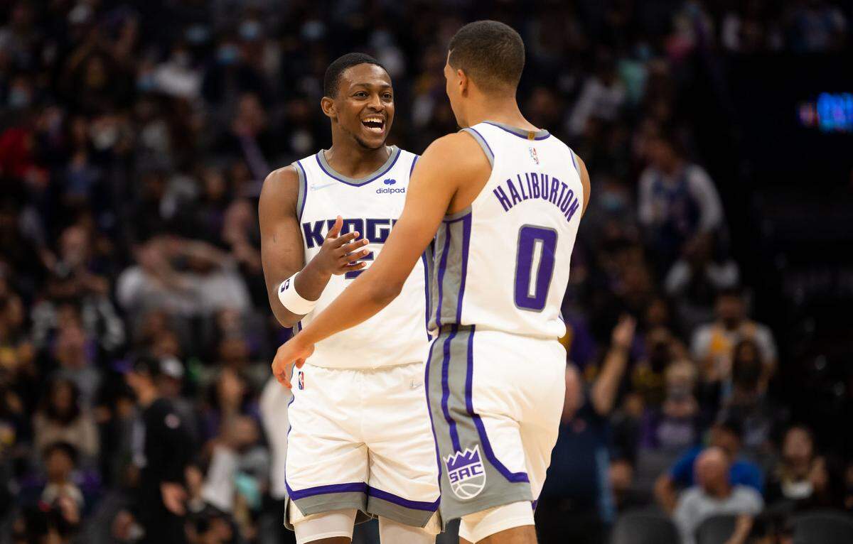 Sacramento Kings guard De’Aaron Fox (5 congratulates Tyrese Haliburton on a swinging a three pointer during a preseason game against the Los Angeles Lakers in 2021.