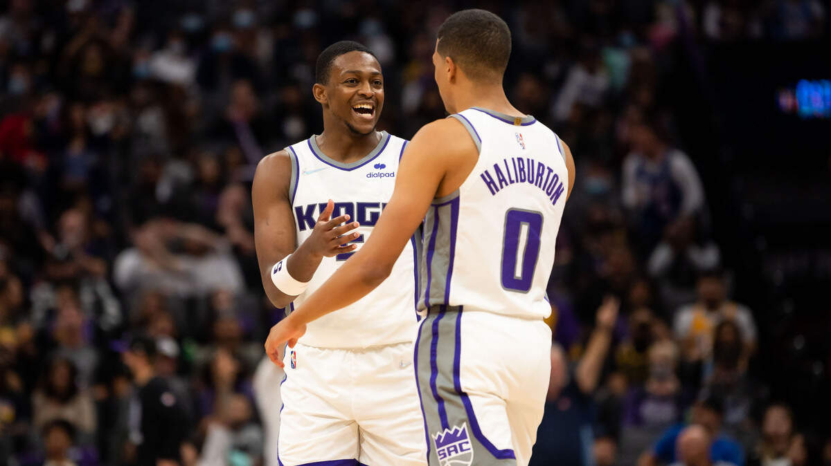 Sacramento Kings guard De’Aaron Fox (5), left, congratulates Tyrese Haliburton on swinging a three pointer against the Los Angeles Lakers in the fourth period of their final preseason NBA basketball game Thursday, Oct. 14, 2021, at Golden 1 Center in downtown Sacramento. The Kings beat the Lakers 116-112.