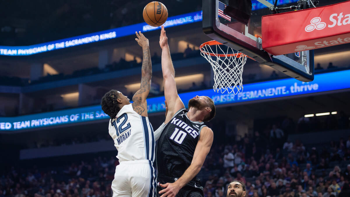 Memphis Grizzlies guard Ja Morant (12) makes a shot over Sacramento Kings forward Domantas Sabonis (10) against during the first quarter of the NBA basketball game Thursday, Oct. 27, 2022, at Golden 1 Center in Sacramento.