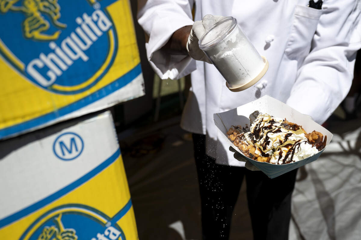 Chef Louis Bynoe prepares a funnel cake topped with caramelized bananas, Dubai chocolate and whipped cream at the Sacramento Banana Festival at William Land Park on Sunday.