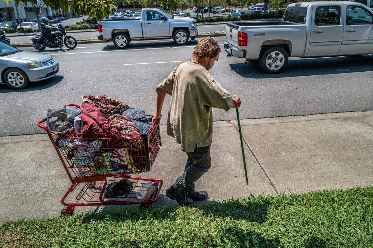 Mark Rippee uses a broken broom stick as a cane as he navigates along Monte Vista Avenue in Vacaville on July 27. He has been hit by cars and police have been called to rescue him after he’s walked out into traffic.