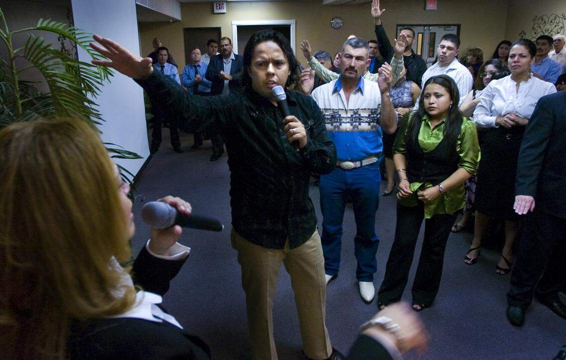 Samuel Rodriguez, center, preaches to his congregation in 2009 as his wife Eva Rodriguez, left, translates in Spanish.
