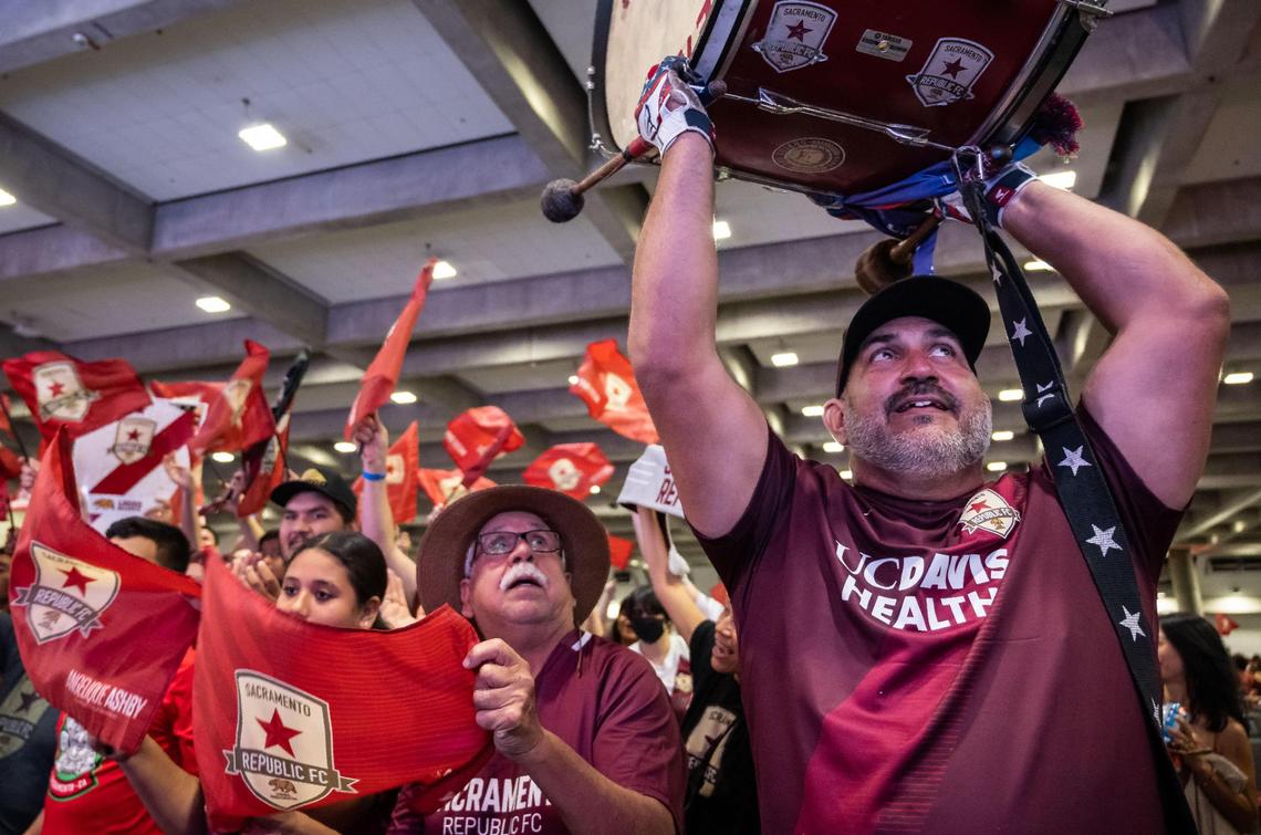 Tower Bridge Battalion drummer Ben Viramontes, right, of Sacramento, watches a live shot on the big screen during the watch party at SAFE Credit Union Convention Center as Sacramento plays Orlando City SC at the U.S. Open Cup final Wednesday, Sept. 7, 2022, at Exploria Stadium in Orlando.