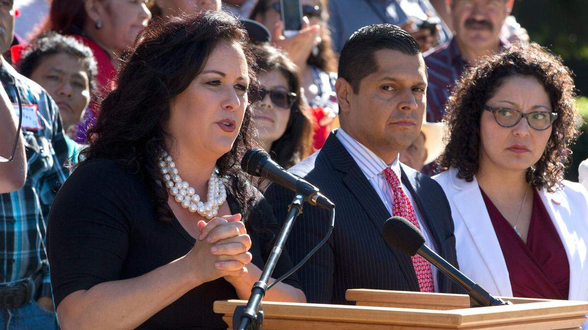 FILE - Assemblywoman Lorena Gonzalez, left, speaks at a rally supporting her bill that would require farmworkers to receive overtime after working eight hours, starting in 2019, Thursday, Aug. 25, 2016, in Sacramento, Calif. Gonzalez, a Democrat from San Diego, announced on Monday, Jan. 3, 2022, that she is resigning from the Legislature and will become the next leader of the California Labor Federation. She will replace Art Pulaski, who is expected t retire in July.