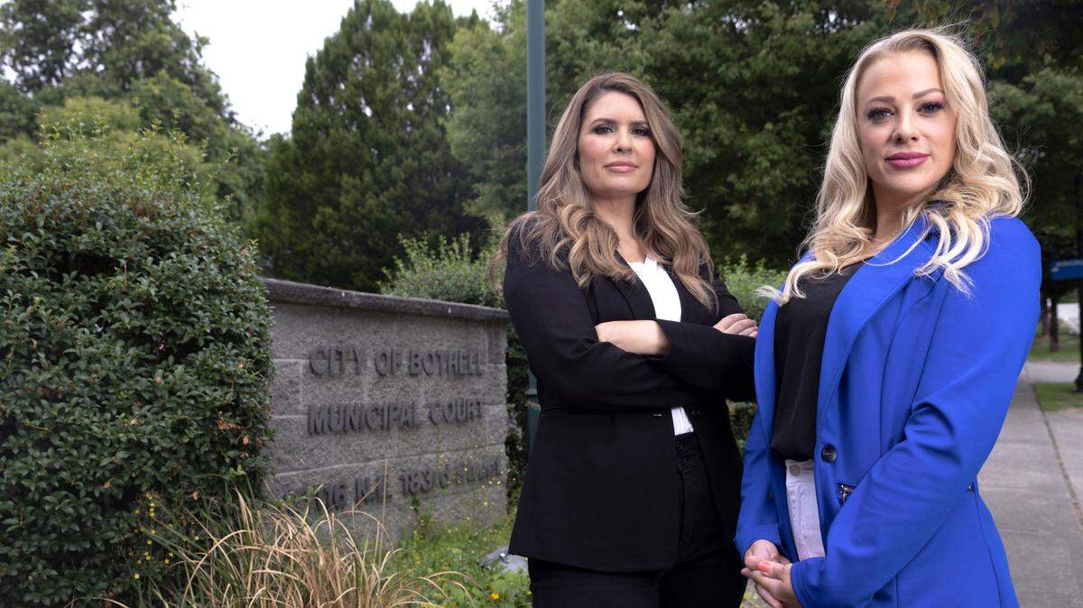 Amber Rasmussen, left, and Athena Klingerman, former wives of con man Brandon Johnson, stand in August outside the Bothell, Wash., court house where in 2019 they took him to court and won a five-year, no-contact plea deal against him. Once archenemies, they now have the true-crime podcast “Ex-Wives Undercover” about their experience and about spotting duplicitous online lovers.