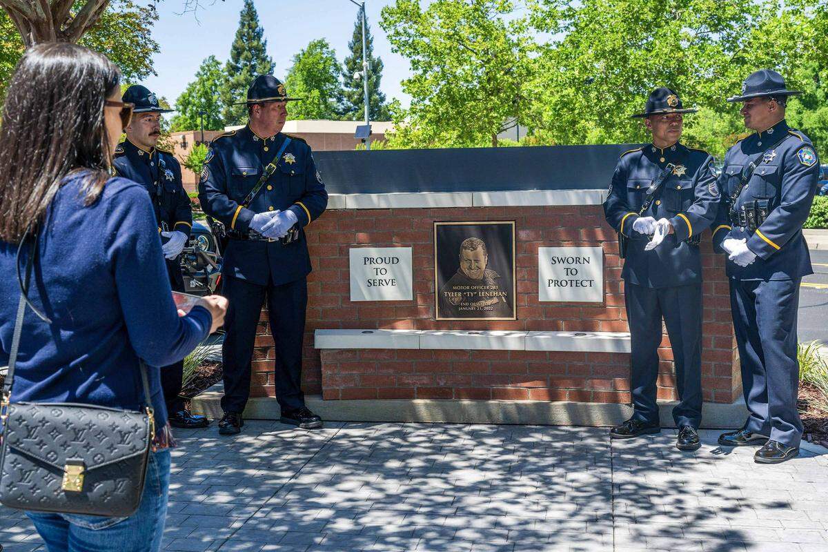 The Elk Grove police honor guard prepares to pose for a photo by a memorial plaque honoring fallen Officer Ty Lenehan, who died in the line of duty in 2022, during a dedication ceremony on Wednesday in Elk Grove. The Elk Grove Police Department renamed its campus the Officer Ty Lenehan Public Safety Center and unveiled the plaque recognizing his service and legacy.