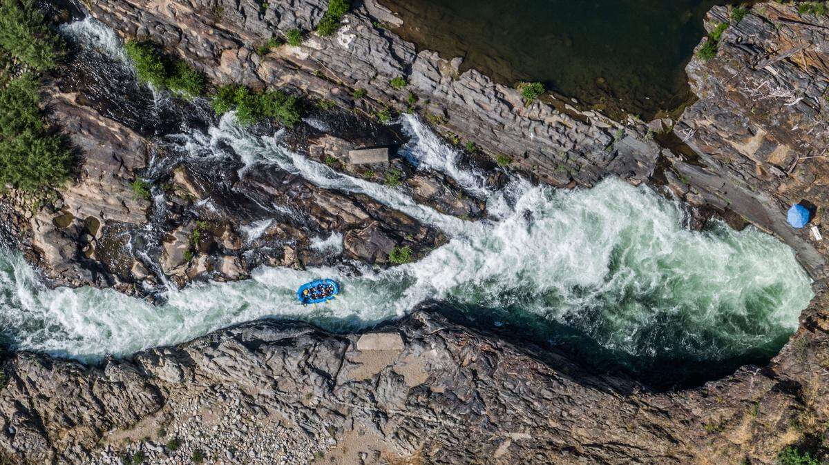 Passengers on a raft prepare to enter the man-made Tunnel Chute on the Middle Fork of the American River on Sunday. The Class IV+ rapid was created by gold miners in the 1890s, who blasted a tunnel to shorten the river’s route and expose the gold-rich riverbed of an oxbow bend.