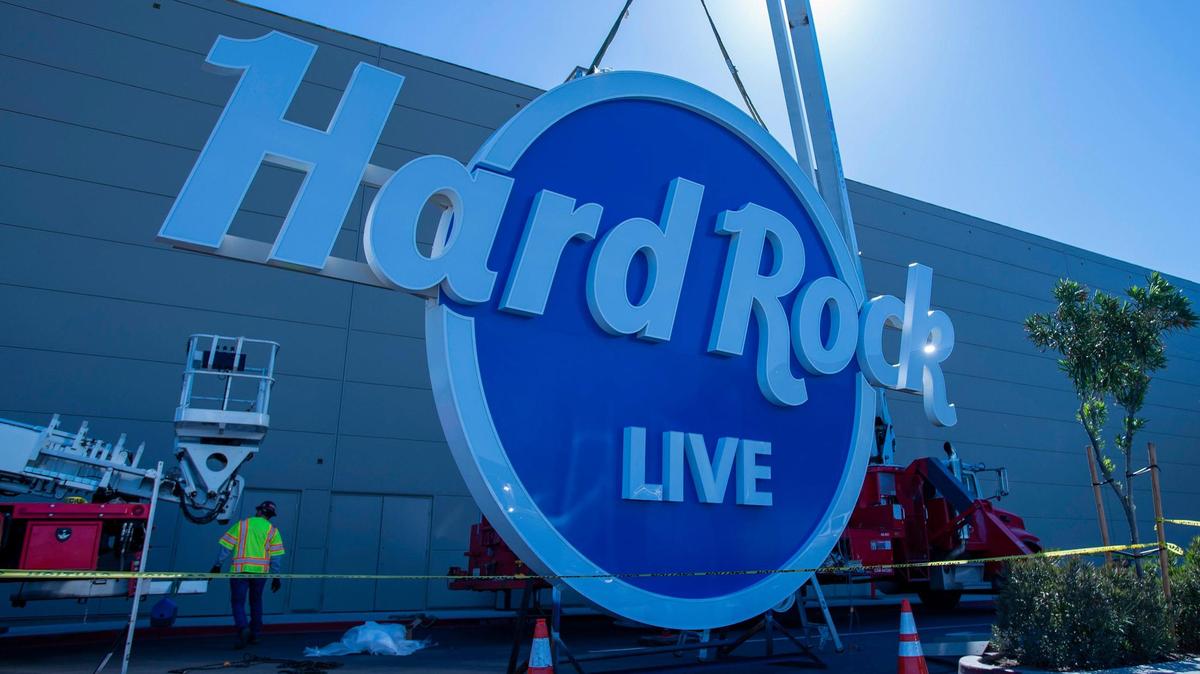 Workers get the new sign ready to be installed for the Hard Rock Live venue at the Hard Rock Hotel and Casino on Monday, March 21, 2022, in Wheatland.