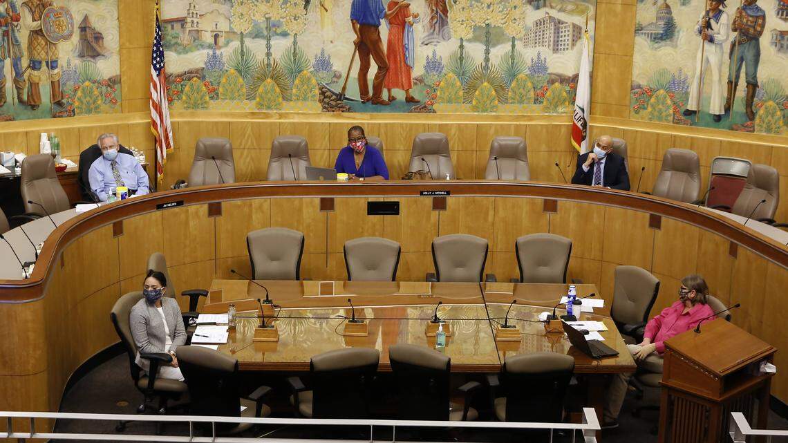 Following social distancing guidelines, members and staff of the Senate budget committee stay six feet apart, during a hearing of the special subcommittee on COVID-19, at the Capitol in Sacramento, Calif., Thursday, April 16, 2020. Lawmakers are looking into how Gov. Gavin Newsom has been spending money to address the new coronavirus crisis. Due to the unusual circumstances only Sen. Jim Nielsen, R-Gerber, left, vice chair of the committee and Sen. Holly Mitchell, D-Los Angeles, center, chair of the budget committee, attended the hearing in person while other committee members joined by video. (AP Photo/Rich Pedroncelli, Pool)