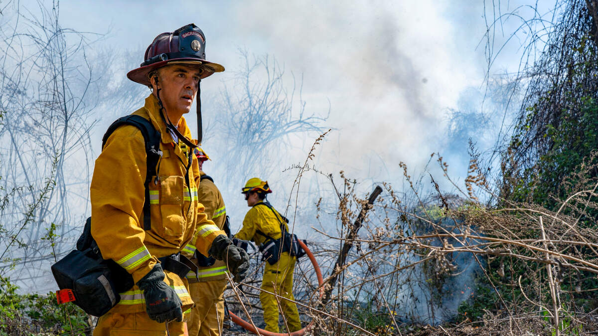 Firefighters with the Sacramento Fire Department work to put out a two-alarm fire near Discovery Park on Friday near the American River.