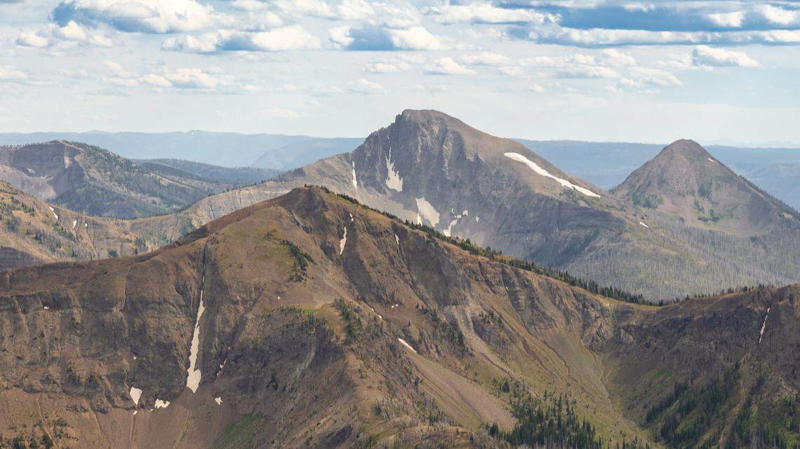 First Peoples Mountain (center) rises between Top Notch Peak (foreground) and Mt. Stevenson (back right) seen from Avalanche Peak. (NPS / Jacob W. Frank)