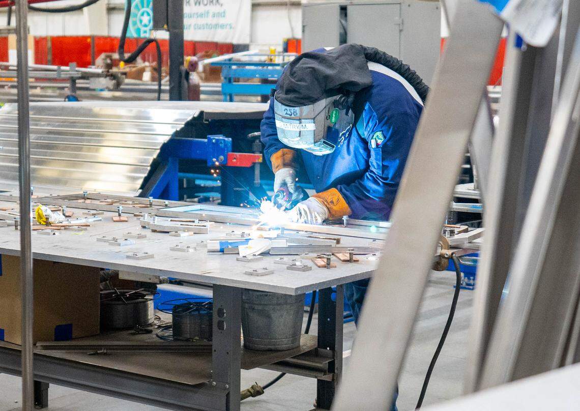 A Siemens worker assembles part of an Amtrak Airo train at the company’s manufacturing facility in Sacramento in 2023.