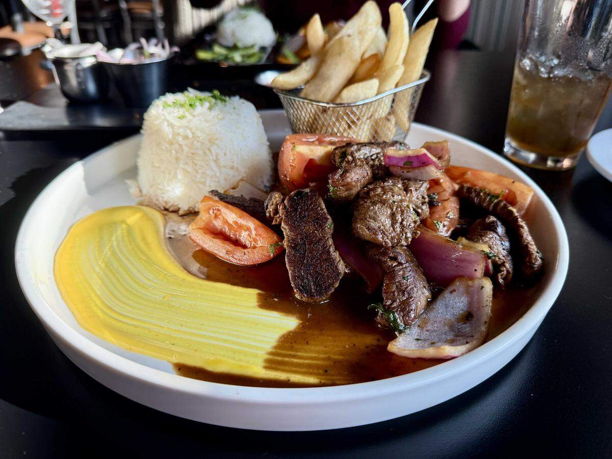 Paititi Peruvian Bistro's pairs tender strips of beef sauteed with peppers and onions, served with steak fries and rice.