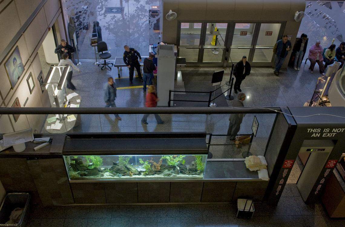 Fish swim in a huge tank in 2010 installed with the intention of calming visitors in the entry of the Sacramento County Main Jail.