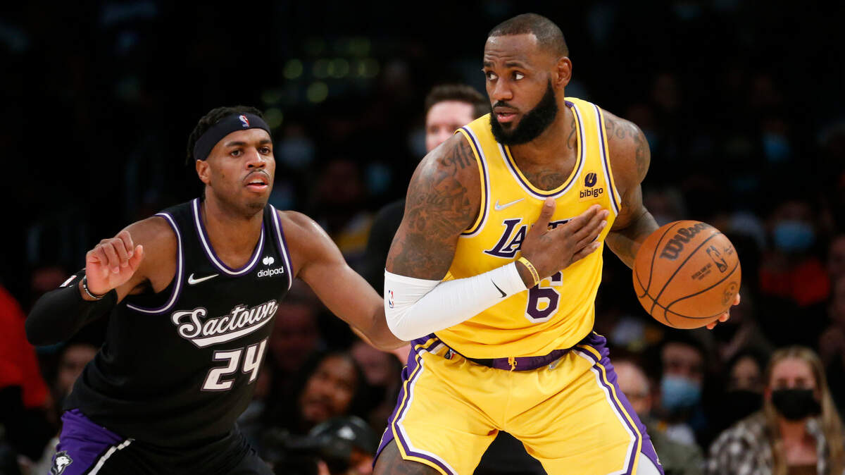 Los Angeles Lakers forward LeBron James (6) is defended by Sacramento Kings guard Buddy Heild (24) during the second half of an NBA basketball game in Los Angeles, Friday, Nov. 26, 2021. The Kings won 141-137 in triple overtime. (AP Photo/Ringo H.W. Chiu)