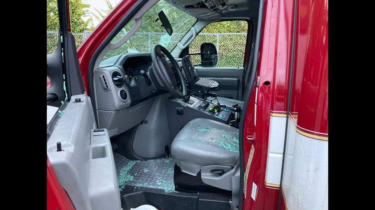 Firefighters fled a parked ambulance when an attacker broke the windows, then stole it and chased them in a San Francisco parking lot, California police say.