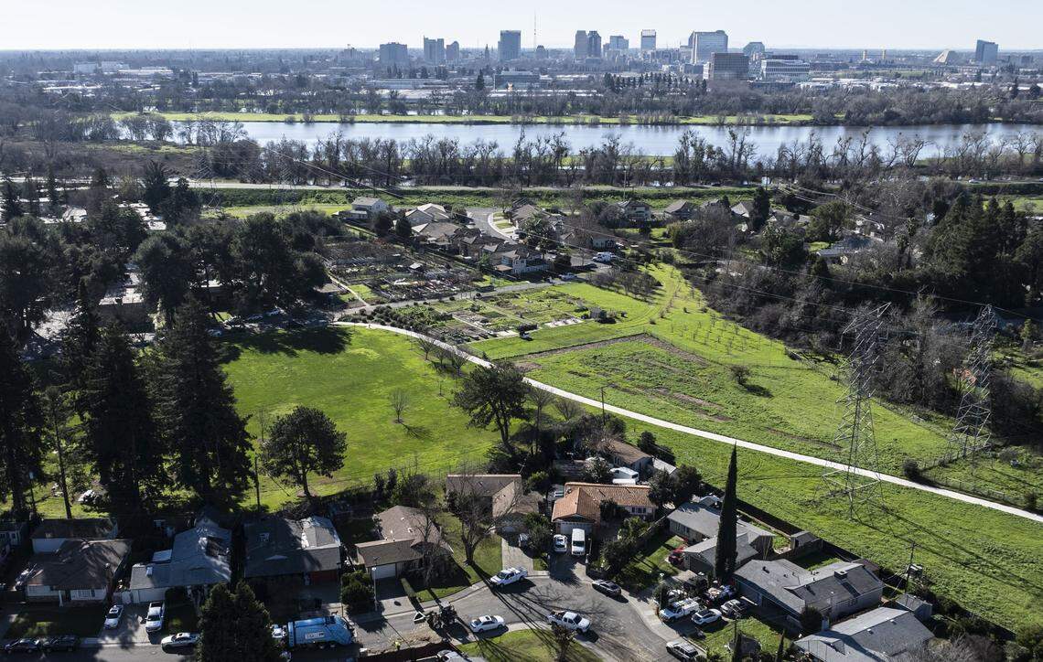 Marie Raymond, a city of Sacramento Claw operator, places yard waste into a garbage truck in South Natomas not far from the American River on Jan. 9.