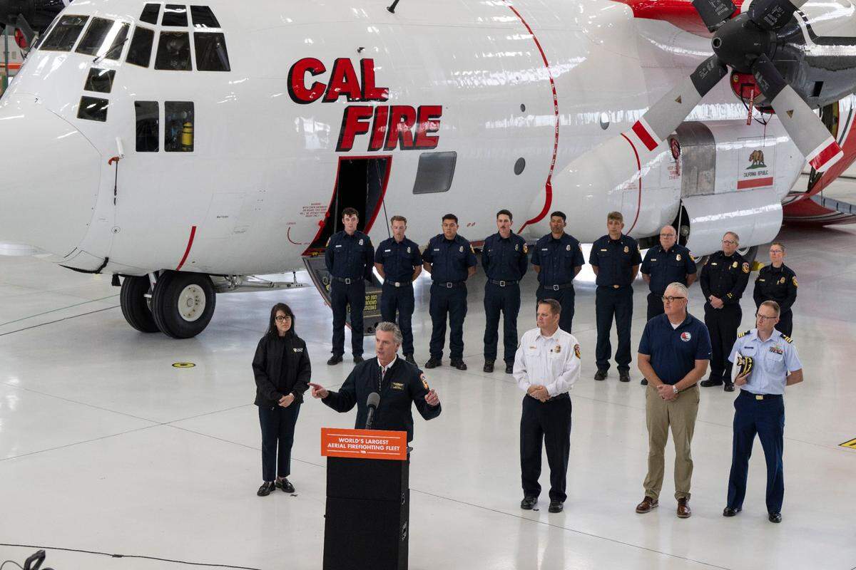 Gov. Gavin Newsom speaks about the Cal Fire’s new C-130H firefighting airplane during a press conference at McClellan Park on Thursday.