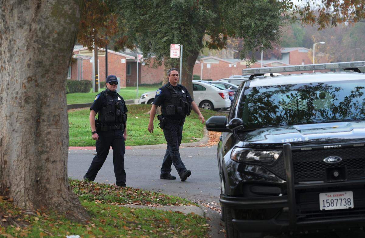 Police officers investigate the scene of a shooting at Seavy Circle in Sacramento on Wednesday, Nov. 17, 2021.