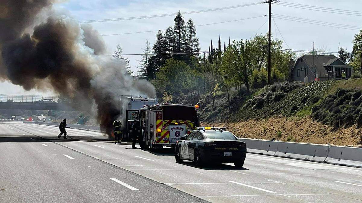 Smoke pours from a garbage truck on Highway 50 near East Sacramento on Friday, April 9.