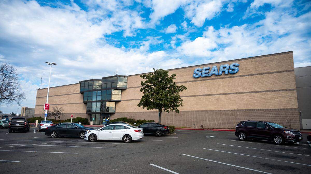 Cars are parked outside the parking lot of Sears minutes after it opens at Arden Fair mall in Sacramento on Monday, Feb. 1, 2021. Arden Fair owners acquired on July 28, 2023, the roughly 156,000 square-foot retail space and 369,000 square-foot parking parcel left by Sears’ closing in April 2021.