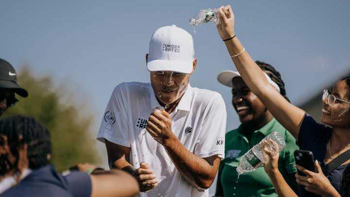 Jayden Lizama gets doused with water by friends and family after winning the Curry Cup on Saturday, Sept. 13, 2025, at Liberty National Golf Club in Jersey City, N.J. Lizama shot 8 under par to win the boys’ title at the Underrated Golf Tour’s championship event, marking his first tournament victory on the tour.