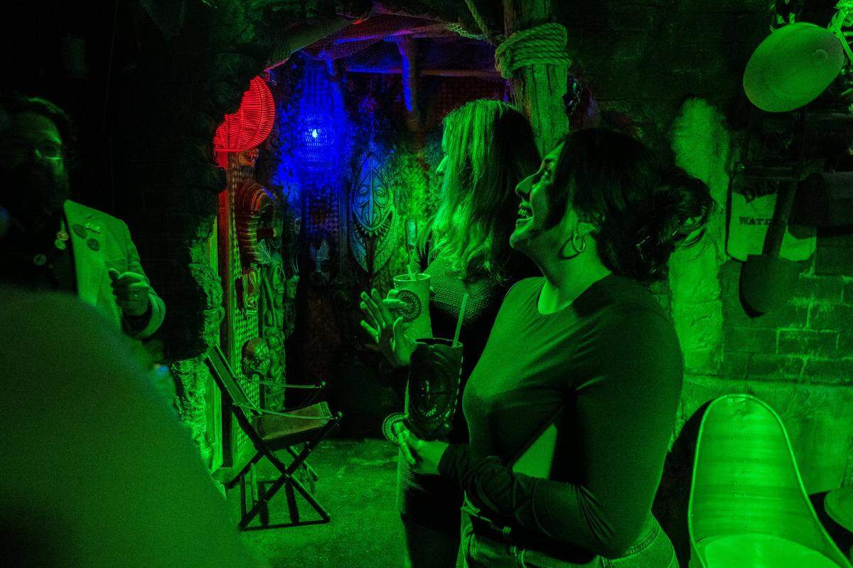 Crystal Vazquez, right, and Caitlin Temple enjoy the light show that accompanies their cocktail order at Hawthorne’s Hideout on Thursday, Nov. 6, 2025, a tiki-themed underground speakeasy in Old Sacramento.