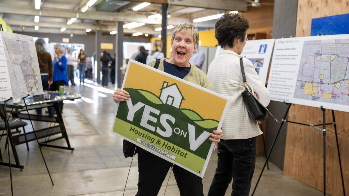 Tracy Tomasky of Davis carries out a Yes on V sign before a kick-off rally for the measure in Davis on Wednesday, March 4, 2026. The measure is trailing by 4 points with about half of votes counted. 