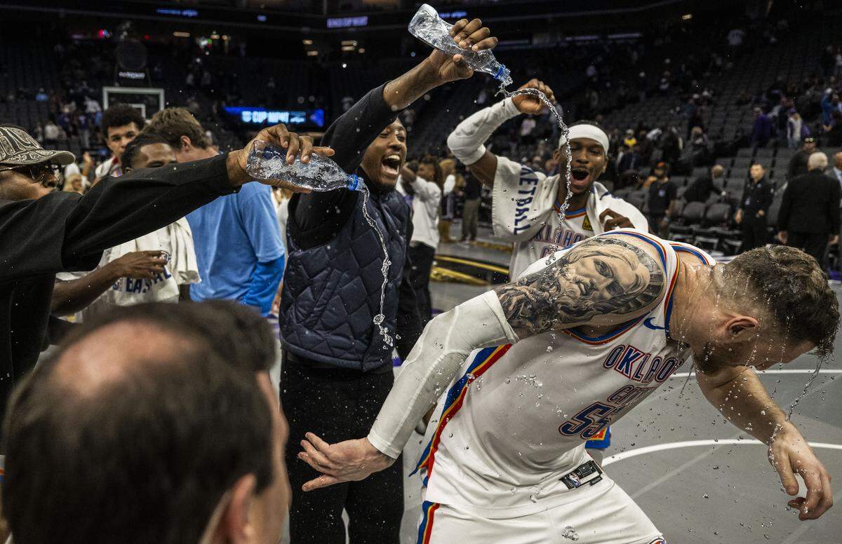 Oklahoma City Thunder center Isaiah Hartenstein is doused by his teammates after leading them to a 132-101 victory against the Sacramento Kings during an Emirates NBA Cup in-season tournament game at Golden 1 Center on Friday. Hartenstein had a game-high 33 points.
