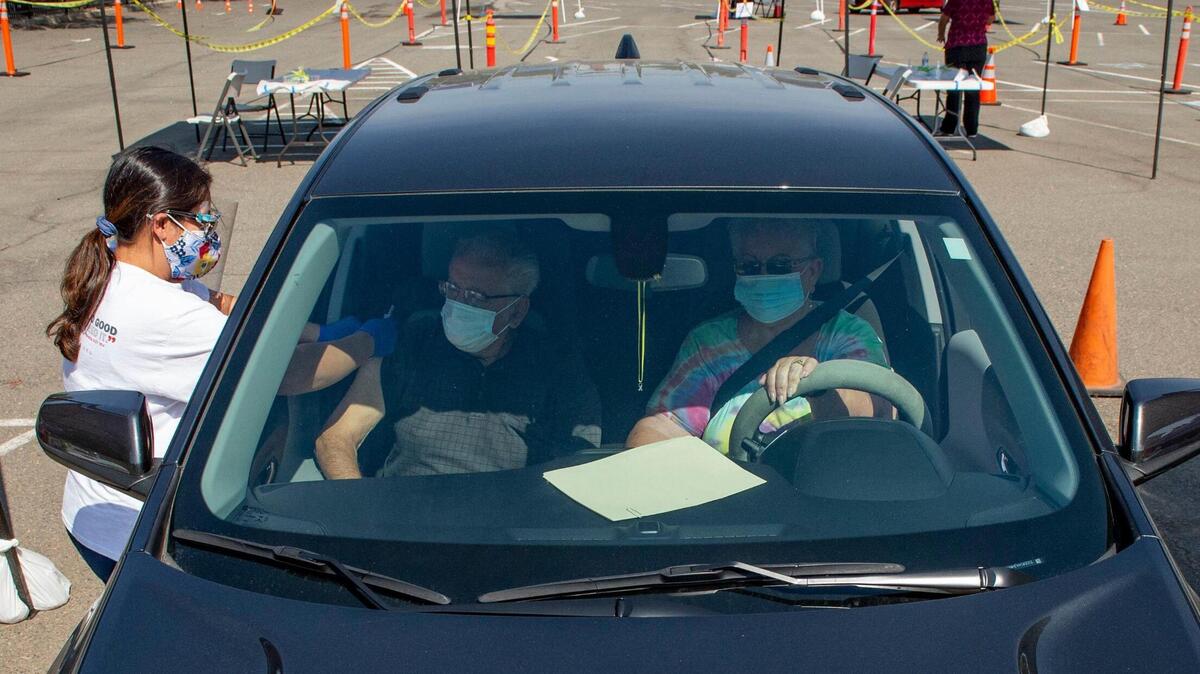 Efrain and Barbara Corona sit in their car as a nurse administers a flu shot at a Sacramento County flu vaccine clinic hosted at The Church of Christ in South Sacramento on Saturday, Sept. 26, 2020. Sacramento County will begin vaccine clinics for flu shots and COVID-19 vaccines next week.