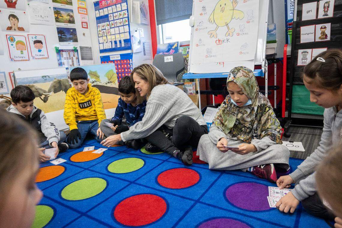 Krista Bitonti, a new English language development teacher at Dyer-Kelly Elementary School, works on a word game earlier this month with students, from left, Mohammad Baktash Aslamyar, Samir Nasari, Mohammad Jahed Amiri, Sumay Mashwani and Aisha Syed Miri. “It’s quite the privilege to be able to welcome newcomers to our country and make them feel safe and find a new home,” Bitonti said.