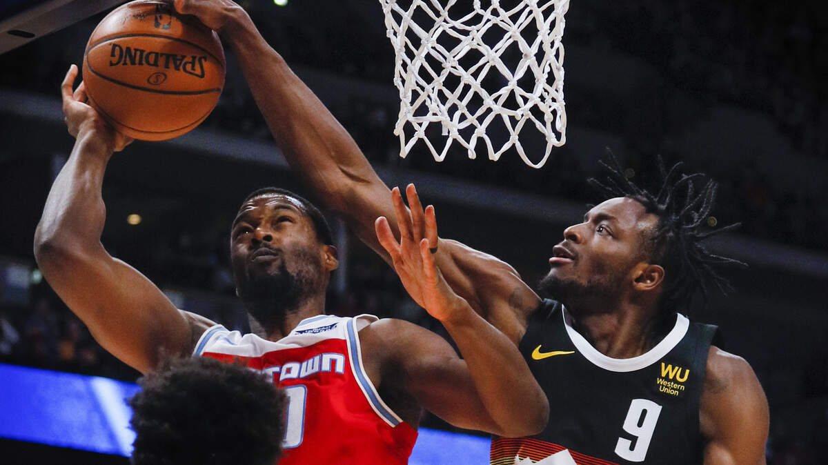 Denver’s Jerami Grant blocks a shot from Sacramento’s Harrison Barnes on Sunday.