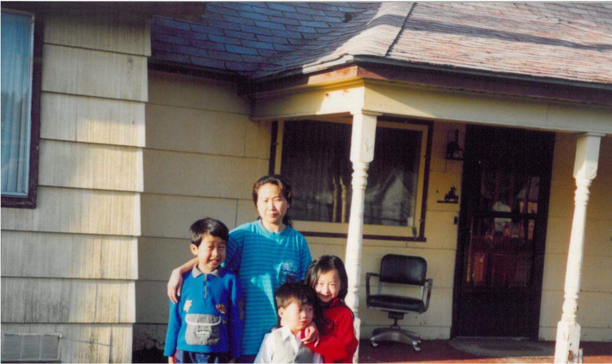 Young, Paha and Tommy pose with their mother at their house in Sacramento in 2002.