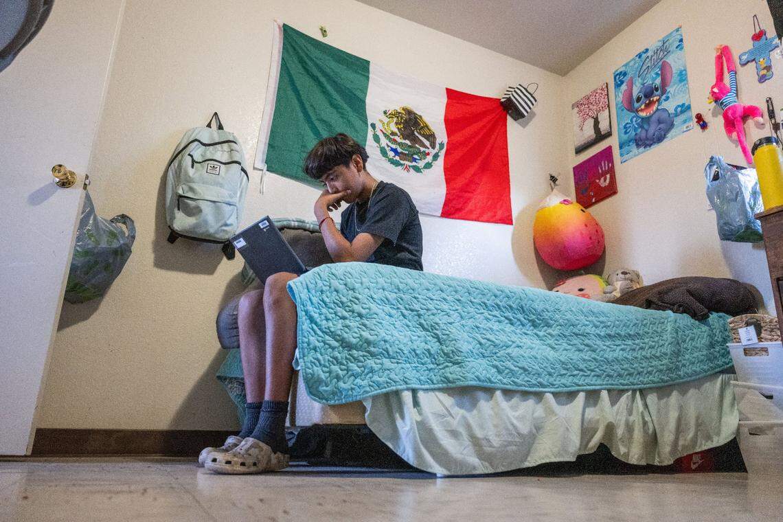 Juan Miguel Acevedo Perez, 13, does school homework at the Lodi Migrant Center. His mother Lorena hopes her children will escape the migrant life.