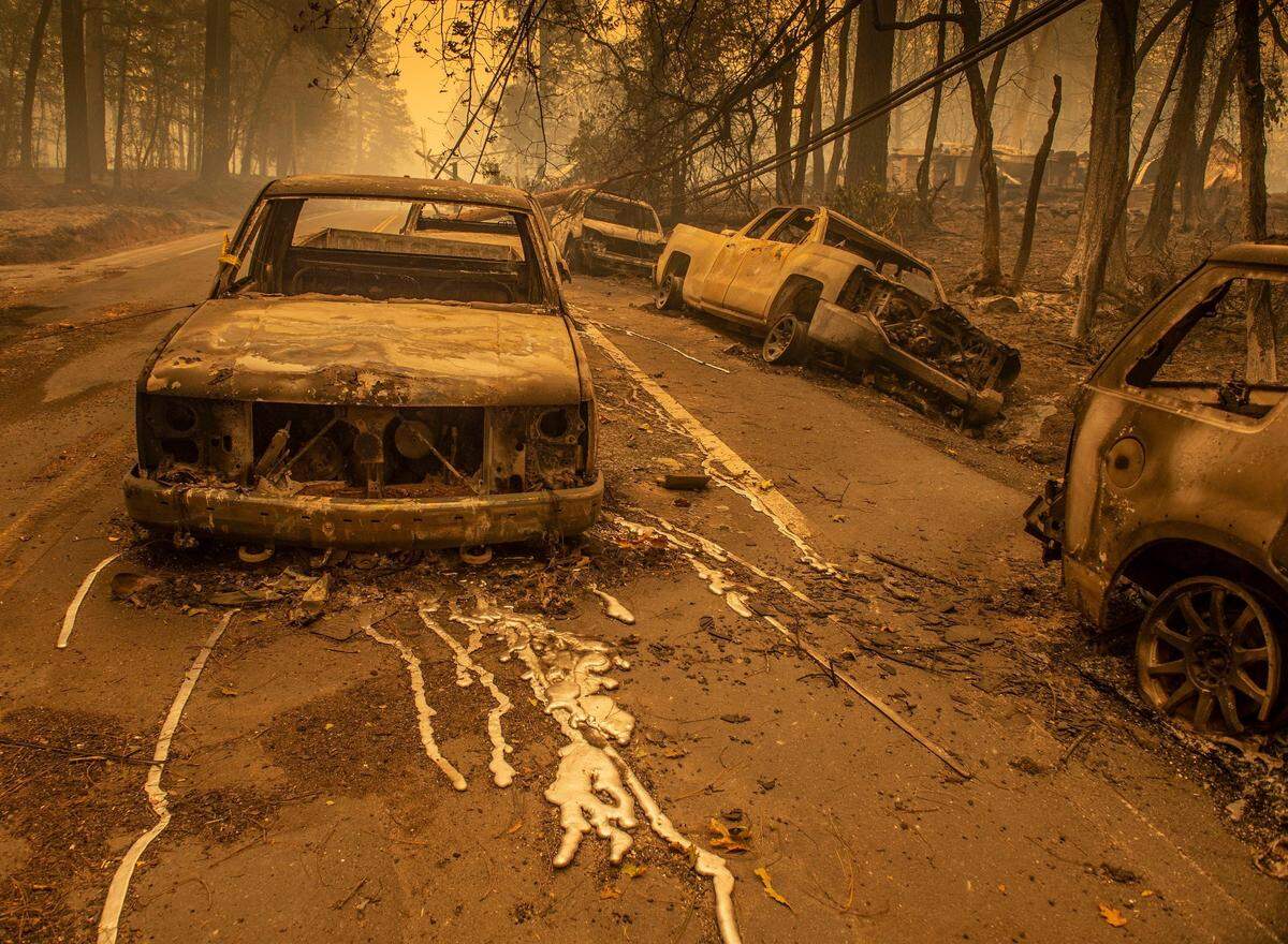 The charred remains of vehicles sit on Pearson Rd. on Friday Nov. 9, 2018.