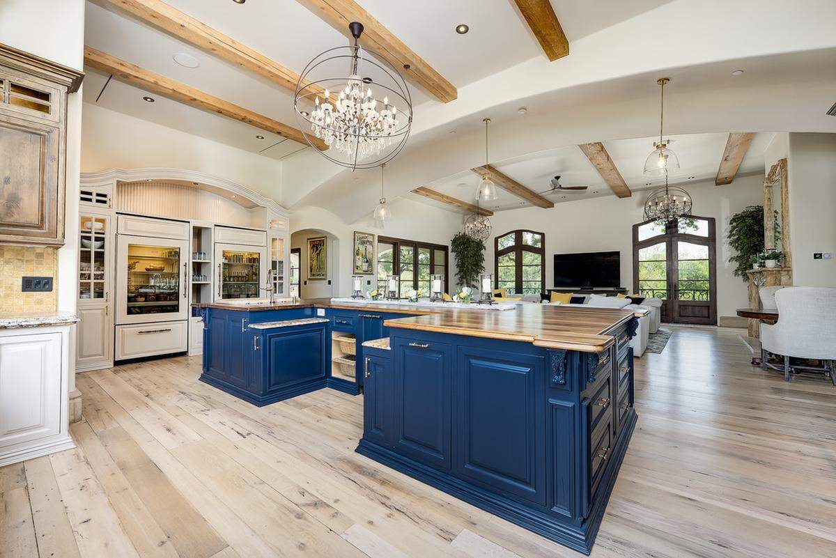 A chef’s kitchen is well-appointed with the highest quality of appliances: La Cornue, Sub Zero, Gaggenau and Miele appliances. The island is topped with walnut.