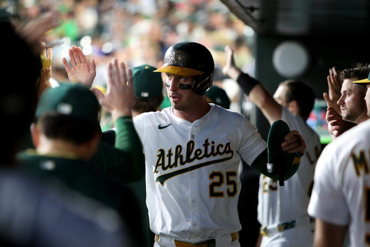 Aug 16, 2025; West Sacramento, California, USA; Athletics designated hitter Brent Rooker (25) celebrates with teammates after scoring a run against the Los Angeles Angels during the third inning at Sutter Health Park. Mandatory Credit: Dennis Lee-Imagn Images