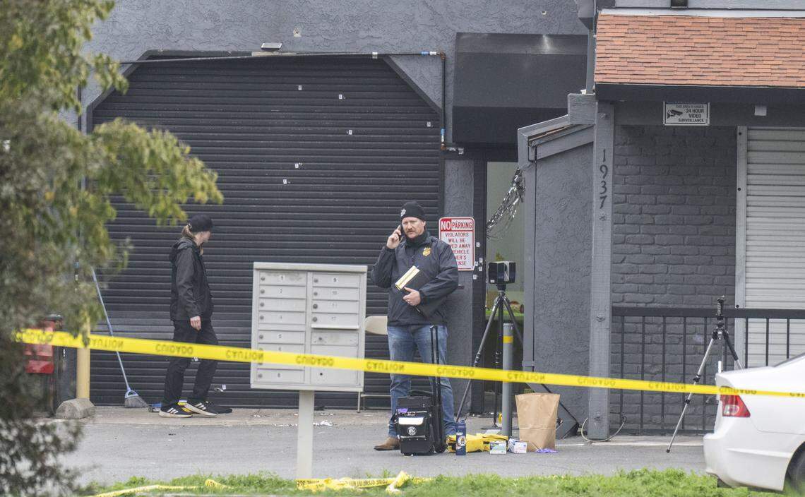An ATF officer talks on his cellphone Sunday at the site of a mass shooting near Stockton the night before. 